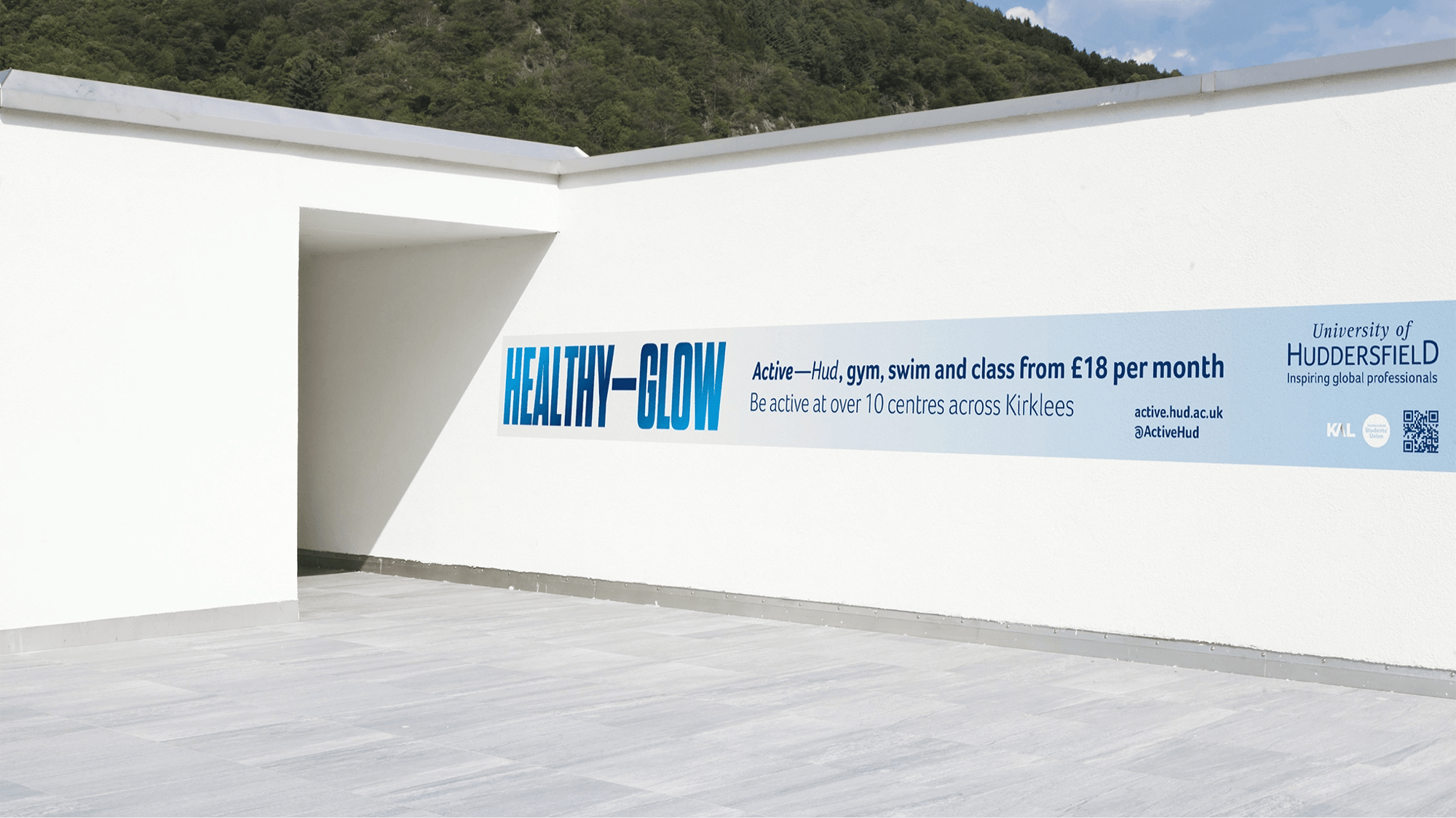 The new branding applied to a wall outside the university facilities.