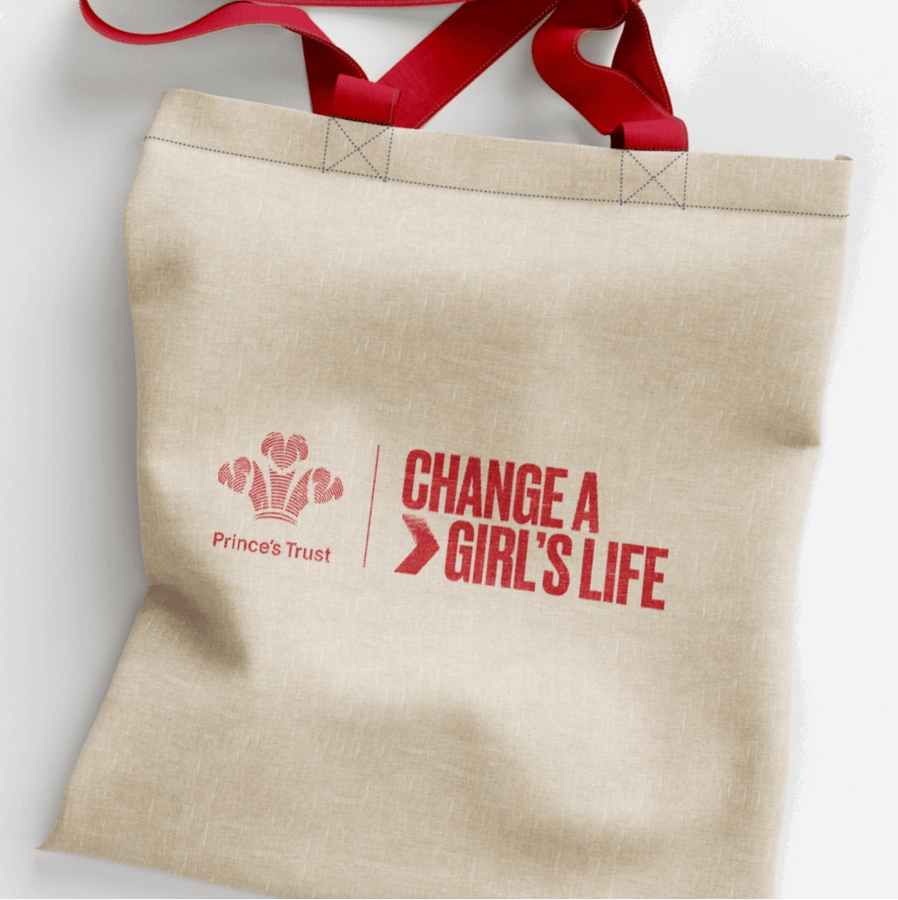 A tote bag with the words 'change a girl's life' printed on it.